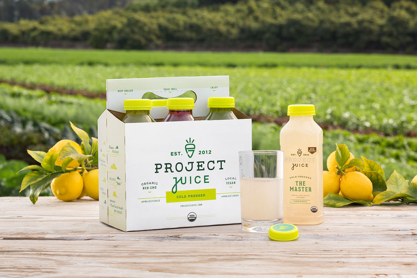 Project Juice packaging with lemons against farmland