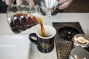 Pouring into a Coffee Cultures branded mug