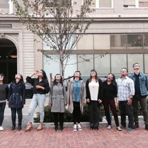 CDA staff outside with solar eclipse sunglasses