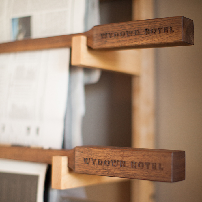 Wydown Hotel custom news rack poles