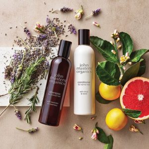 John Masters Organics shampoo and conditioner photographed with ingredients