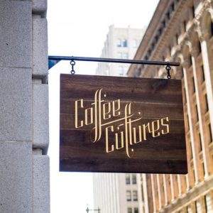 Coffee Cultures gold lettering on wooden blade sign