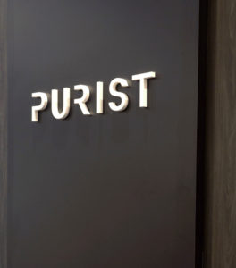 Purist logotype on trade show booth