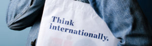Detail of Think internationally. book bag