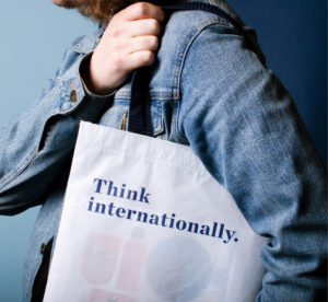 Think internationally. book bag on shoulder