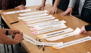 Hands around a table at a strategy workshop