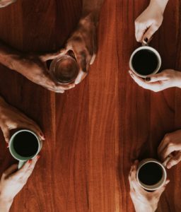 Top view of coffee mugs and hands