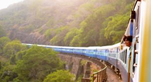 Woman looking out of a train on a hillside