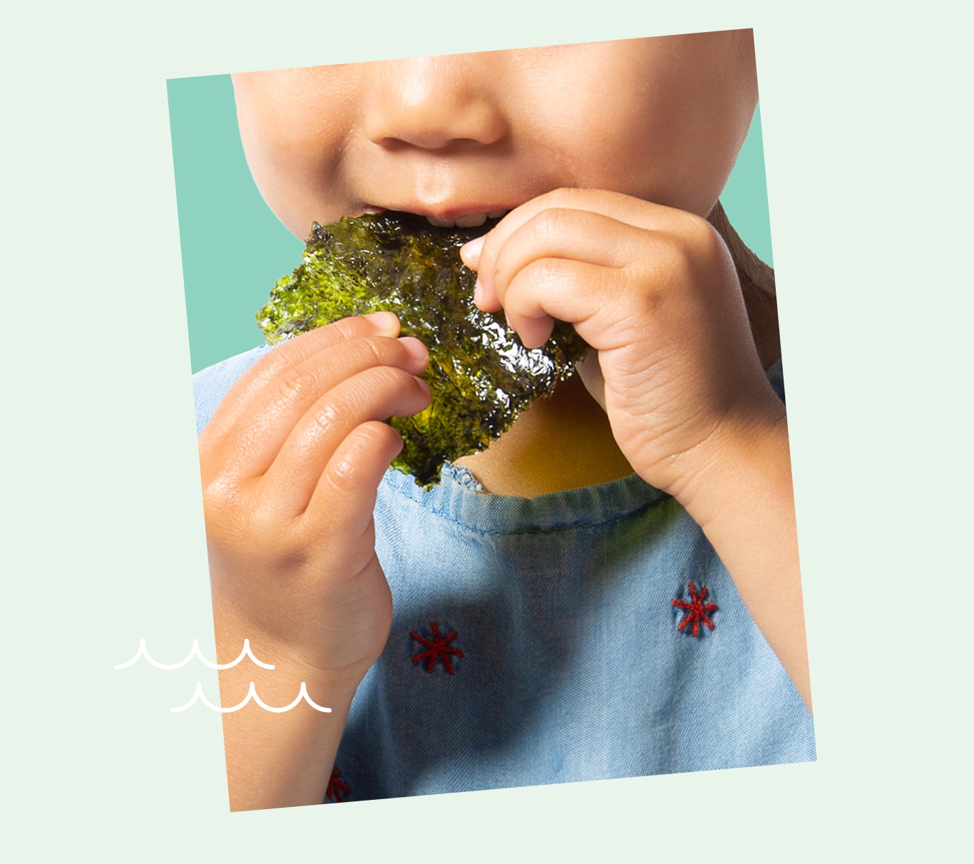 Photo of a young girl enjoying a seaweed snack