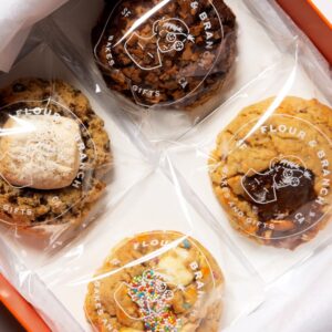 Set of four boxed cookies in Flour & Branch branded plastic sleeves