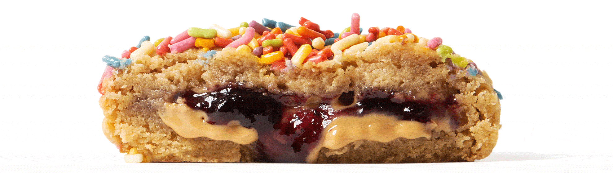 Cross section of the PB&J cookie showing the peanut butter and jelly filling oozing out