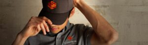 Man wearing branded Giampolini Group cap and work shirt