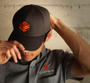 Man wearing branded Giampolini Group cap and work shirt