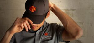 Man wearing branded Giampolini Group cap and work shirt