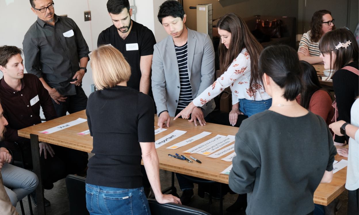 The SB Architects team discusses website features around a large table