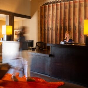 Blurry person stepping toward Wydown Hotel concierge