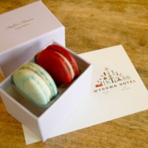 Wydown Hotel branded notecard and box of two colorful macarons