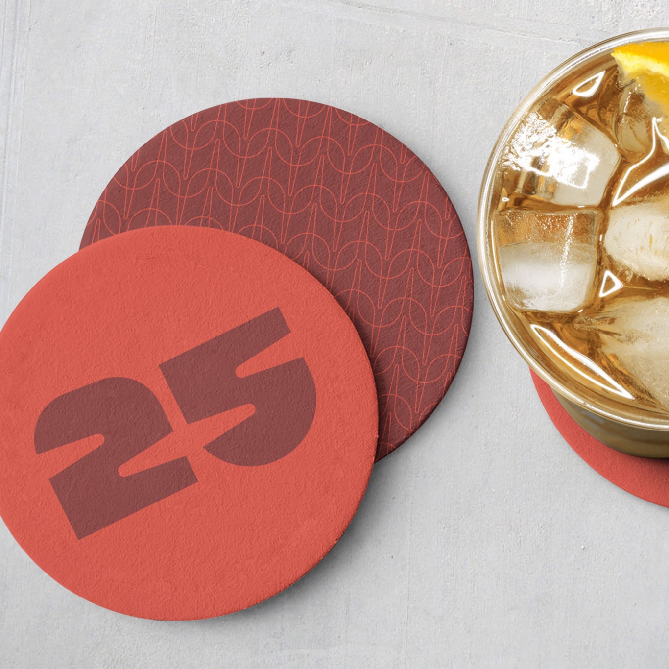 Paper coasters branded with 25th anniversary logo