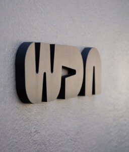 building exterior metal laser cut WDA logo sign